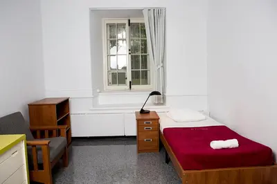 a small bedroom with a bed and a window at The Grey Nuns Residence by Concordia University in Montréal