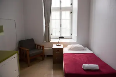 a bedroom with a bed and a chair and a window at The Grey Nuns Residence by Concordia University in Montréal