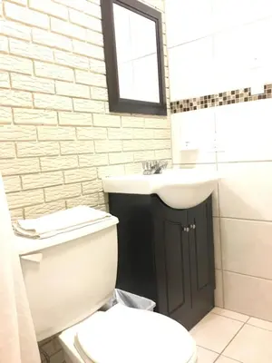 a bathroom with a toilet and a sink at Motel le Sabre in Sherbrooke