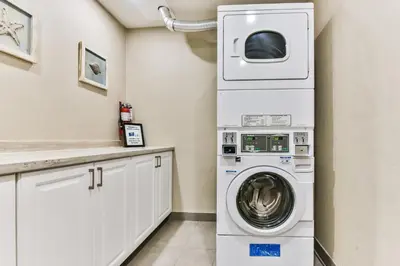 a laundry room with a washer and dryer at Comfort Inn Montreal Aeroport in Pointe-Claire