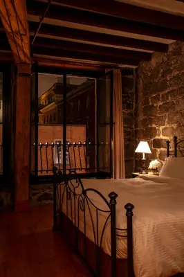 a bedroom with a bed with a view of a building at Auberge du Vieux Port by Gray Collection in Montréal