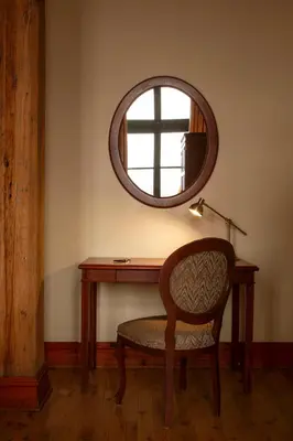 a desk with a chair and a mirror at Auberge du Vieux Port by Gray Collection in Montréal