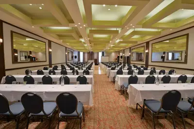 a banquet hall with white tables and chairs at Holiday Inn Montreal Centre Ville Downtown by IHG in Montréal