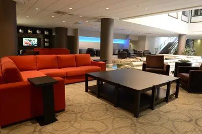 a lobby with orange couches and a coffee table at Holiday Inn Montreal Centre Ville Downtown by IHG in Montréal