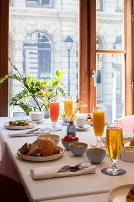 a table with plates of food and drinks on it at Hotel Gault in Montréal