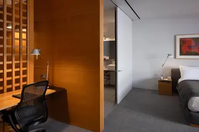 a bedroom with a bed and a desk and a chair at Hotel Gault in Montréal
