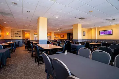 a large dining room with tables and chairs at Sandman Hotel Montreal - Longueuil in Longueuil