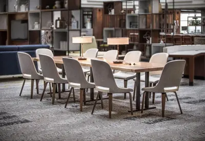 a wooden table and chairs in a room at Holiday Inn Montreal Longueuil by IHG in Longueuil