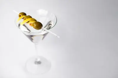 a martini glass with olives and a spoon at Holiday Inn Montreal Longueuil by IHG in Longueuil