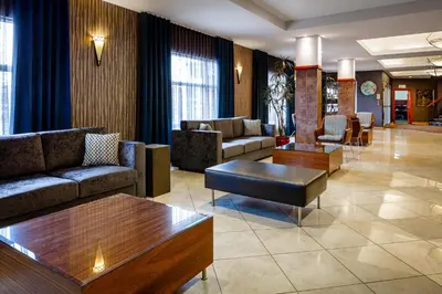 a lobby with couches and tables in a hotel at Auberge Royal Versailles in Montréal