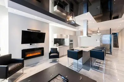 a living room with a fireplace and a table and chairs at Boutique Lofts Milton Parc by Simplissimmo in Montréal