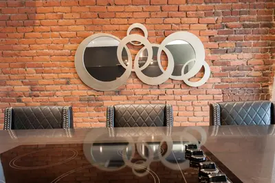 a brick wall behind a table with a sign on it at Boutique Lofts Milton Parc by Simplissimmo in Montréal