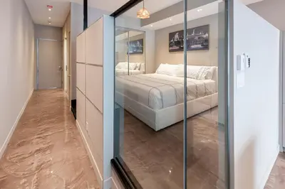 a bedroom with a bed and a glass wall at Boutique Lofts Milton Parc by Simplissimmo in Montréal