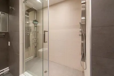 a shower with a glass door in a bathroom at Boutique Lofts Milton Parc by Simplissimmo in Montréal