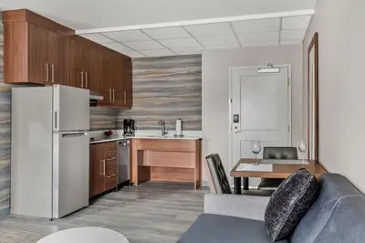 a kitchen with a couch and a table in a room at Residence Inn by Marriott Laval in Laval