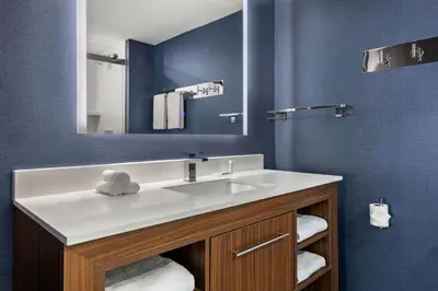 a bathroom with a white sink and a mirror at Residence Inn by Marriott Laval in Laval