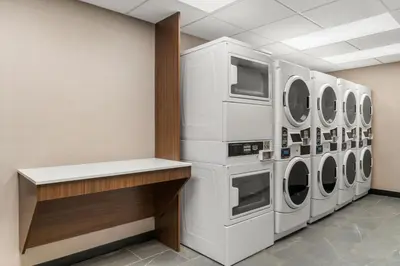 a laundry room with several washers and dryers at Residence Inn by Marriott Laval in Laval