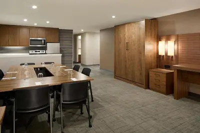a kitchen with a table and chairs in a room at Residence Inn by Marriott Laval in Laval