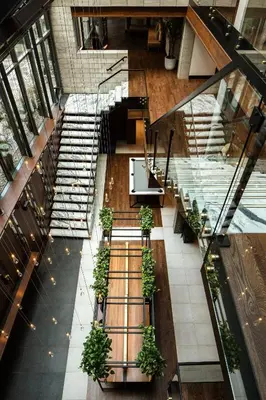an overhead view of a lobby with stairs and potted plants at William Gray by Gray Collection in Montréal