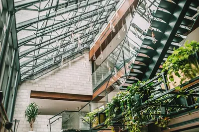 a building with a glass ceiling and some plants at William Gray by Gray Collection in Montréal