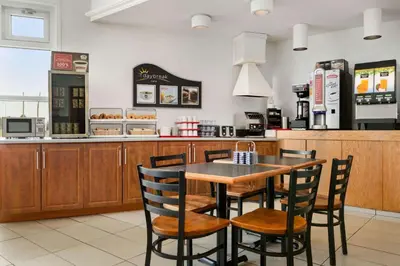 a fast food restaurant with a table and chairs at Days Inn by Wyndham Trois-Rivieres in Trois-Rivières