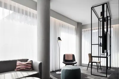 a living room with a couch and a chair at Hotel Monville in Montréal