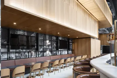 a bar with chairs and tables in a restaurant at Hotel Monville in Montréal