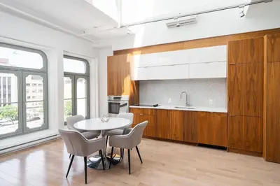a kitchen with a table and chairs in a room at Le Merrill - Vieux Montréal in Montréal