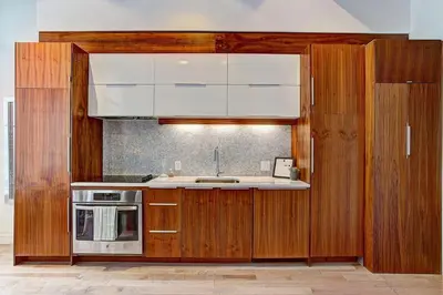 a kitchen with wooden cabinets and a sink at Le Merrill - Vieux Montréal in Montréal