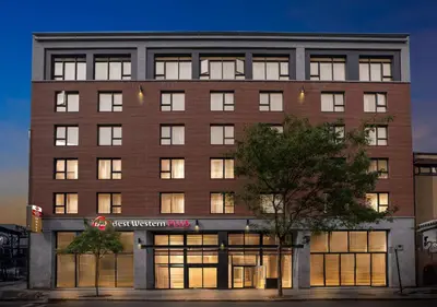 a large brick building with a sign on it at Best Western Plus Hotel Montreal in Montréal