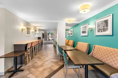 a restaurant with tables and chairs and a bar at Best Western Plus Hotel Montreal in Montréal