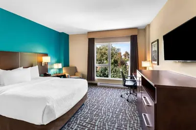 a hotel room with a bed and a flat screen tv at Best Western Plus Hotel Montreal in Montréal