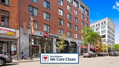 a sign on a street in front of a building at Best Western Plus Hotel Montreal in Montréal
