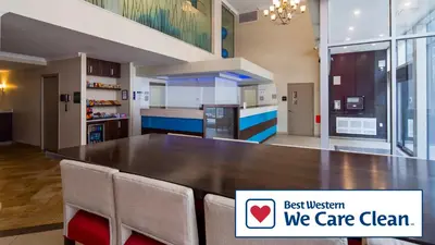 a large kitchen with a large wooden table and chairs at Best Western Plus Hotel Montreal in Montréal