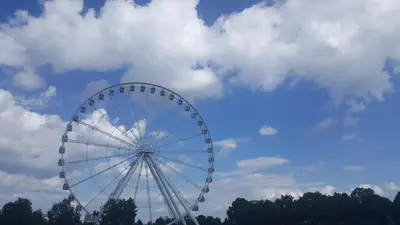a large ferris wheel against a cloudy sky at Best Western Plus Hotel Montreal in Montréal