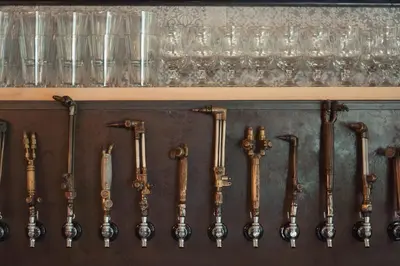 a bunch of utensils hanging on a wall at Auberge Sutton Brouerie in Sutton