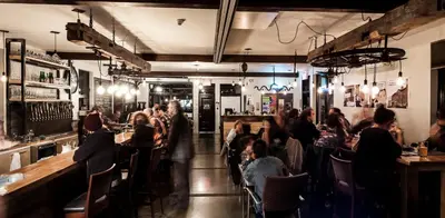 a group of people sitting at a bar at Auberge Sutton Brouerie in Sutton