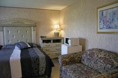 a hotel room with a bed and a couch at Motel Bellevue in Saint-Joseph-de-Beauce
