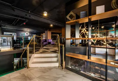 a view of a room with stairs and tables at Empire Suites in Montréal