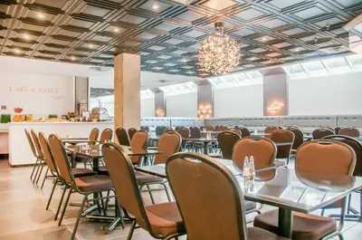 a row of tables and chairs in a restaurant at Empire Suites in Montréal