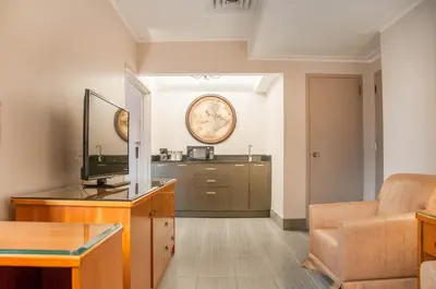 a living room with a television and a couch at Empire Suites in Montréal