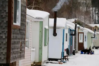 a row of mobile homes covered in snow at Aux Retrouvailles spa à l'année in Lac-Mégantic