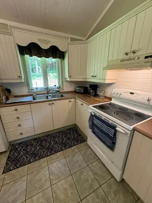 a kitchen with a stove and a sink at Havre De Paix in Piopolis
