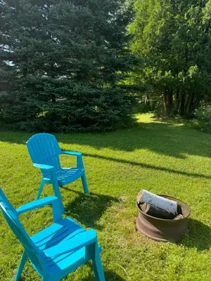 a blue chair sitting next to a fire pit at Havre De Paix in Piopolis