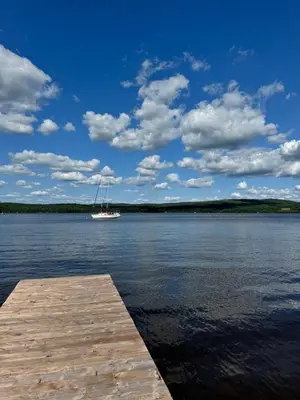 a boat sitting on the water next to a dock at Havre De Paix in Piopolis