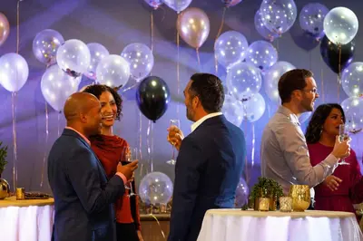 a group of people standing around a table with balloons at Holiday Inn Hotel & Suites - Montreal Centre-ville Ouest by IHG in Montréal
