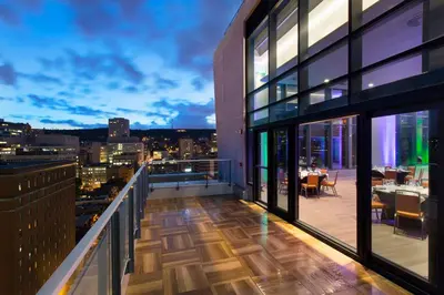 a balcony with a view of a city at night at Holiday Inn Hotel & Suites - Montreal Centre-ville Ouest by IHG in Montréal