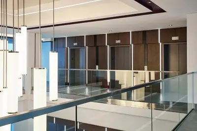 a glass corridor in a building with brown cabinets at Holiday Inn Hotel & Suites - Montreal Centre-ville Ouest by IHG in Montréal