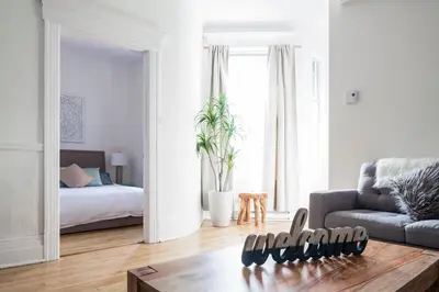 a living room with a couch and a bed at MTLVacationRentals -The Chic Laurier in Montréal
