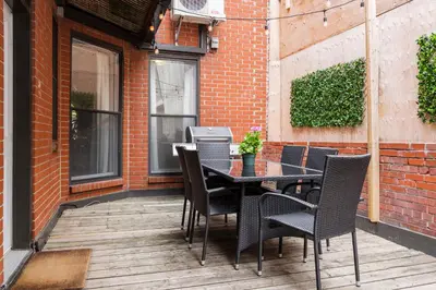 a table and chairs sitting on a patio at MTLVacationRentals -The Chic Laurier in Montréal